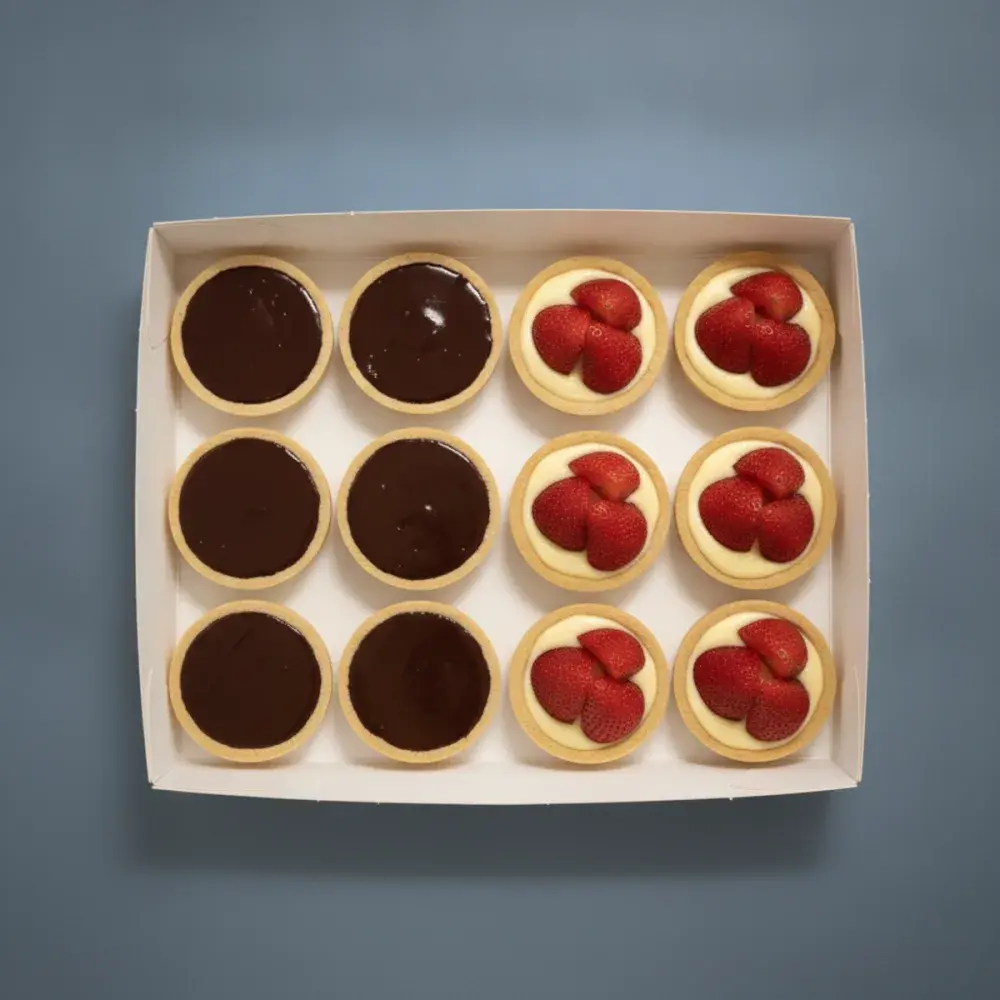 A box of twelve French tarts split between two flavours, six dark chocolate ganache and six strawberry custard